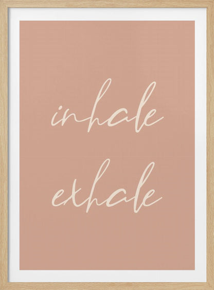 A minimalist framed poster featuring the words 'inhale' and 'exhale' in a flowing white script font, stacked vertically against a solid dusty pink background. Poster