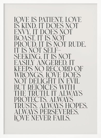 A minimalist art print featuring the 'Love is patient, love is kind...' bible verse from 1 Corinthians 13. The text is printed in a black, all-caps serif font on an off-white background and is surrounded by a simple black frame. Print