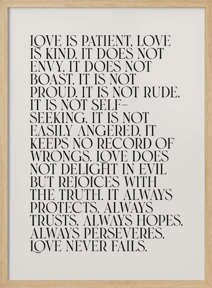 A minimalist art print featuring the 'Love is patient, love is kind...' bible verse from 1 Corinthians 13. The text is printed in a black, all-caps serif font on an off-white background and is surrounded by a simple black frame. Print