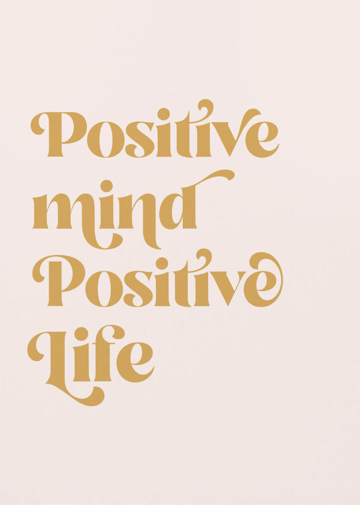 A framed art print featuring the motivational quote 'Positive mind Positive life' in a gold, retro-style font against a light pink background. The text is centered and arranged vertically. Artwork