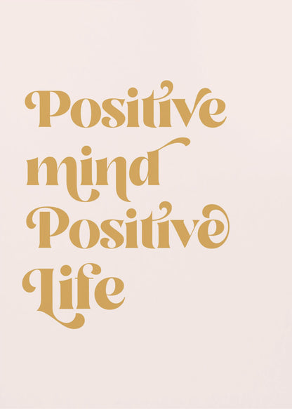 A framed art print featuring the motivational quote 'Positive mind Positive life' in a gold, retro-style font against a light pink background. The text is centered and arranged vertically. Artwork