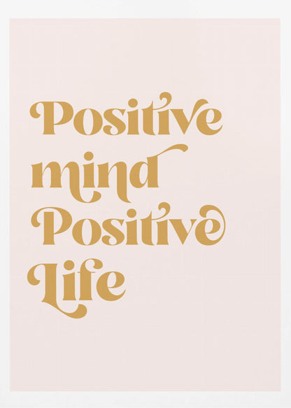 A framed art print featuring the motivational quote 'Positive mind Positive life' in a gold, retro-style font against a light pink background. The text is centered and arranged vertically. Artwork