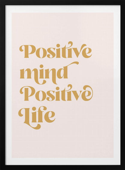 A framed art print featuring the motivational quote 'Positive mind Positive life' in a gold, retro-style font against a light pink background. The text is centered and arranged vertically. Artwork