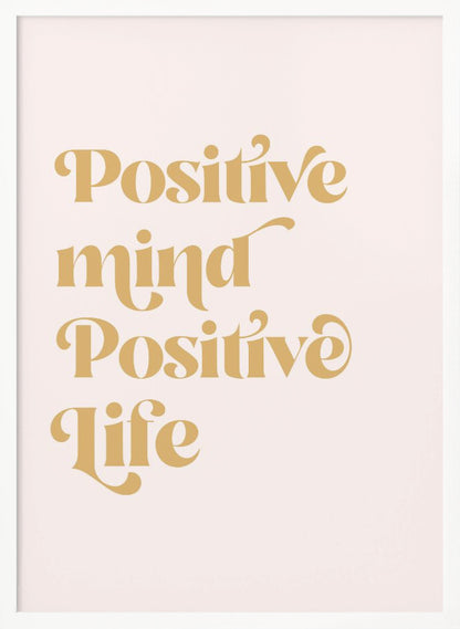 A framed art print featuring the motivational quote 'Positive mind Positive life' in a gold, retro-style font against a light pink background. The text is centered and arranged vertically. Artwork