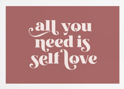 A framed art print with a dusty rose background. In the center, the phrase 'all you need is self love' is written in a creamy white, stylized, retro font. The artwork is enclosed in a simple silver frame. Decor