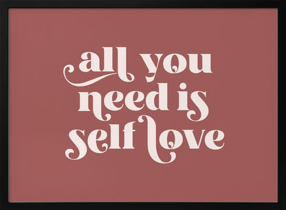 A framed art print with a dusty rose background. In the center, the phrase 'all you need is self love' is written in a creamy white, stylized, retro font. The artwork is enclosed in a simple silver frame. Decor