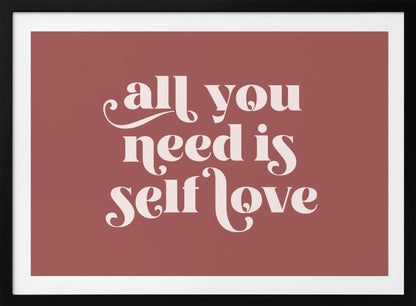 A framed art print with a dusty rose background. In the center, the phrase 'all you need is self love' is written in a creamy white, stylized, retro font. The artwork is enclosed in a simple silver frame. Decor