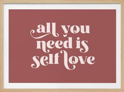 A framed art print with a dusty rose background. In the center, the phrase 'all you need is self love' is written in a creamy white, stylized, retro font. The artwork is enclosed in a simple silver frame. Decor