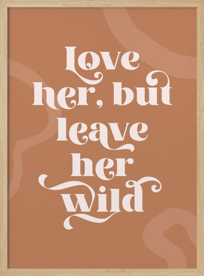 A framed typography poster with a terracotta brown background. In the center, the quote 'love her, but leave her wild' is written in a stylized, decorative, cream-colored font. Faint, lighter brown abstract shapes are visible in the background. Decor