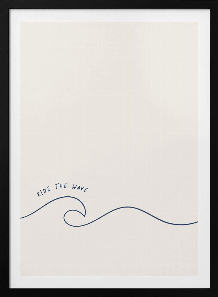 A minimalist art print in a black frame featuring a single dark blue line that forms a simple ocean wave on an off-white background. The words 'RIDE THE WAVE' are written in a casual, handwritten font above the crest. Wall Art