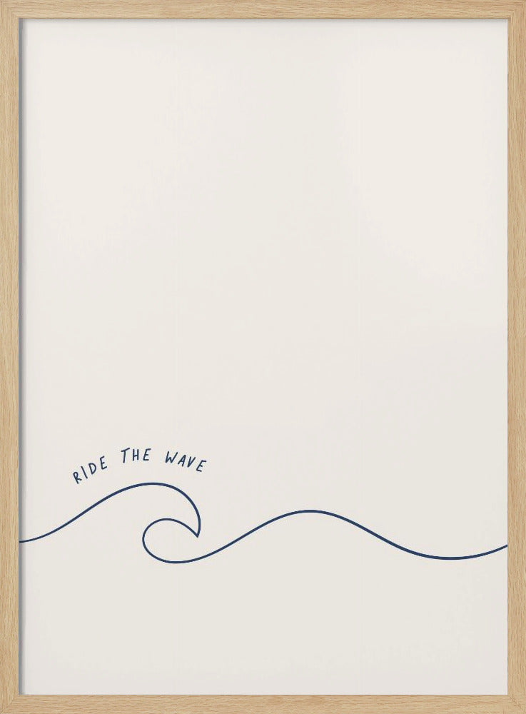 A minimalist art print in a black frame featuring a single dark blue line that forms a simple ocean wave on an off-white background. The words 'RIDE THE WAVE' are written in a casual, handwritten font above the crest. Wall Art