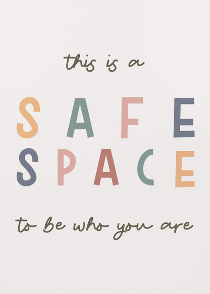 A framed poster with an inspirational message that reads 'this is a SAFE SPACE to be who you are'. The words 'SAFE SPACE' are in large, block letters of various muted colors like orange, sage, pink, and blue, while the rest of the text is in a smaller, dark green script font on an off-white background. Poster