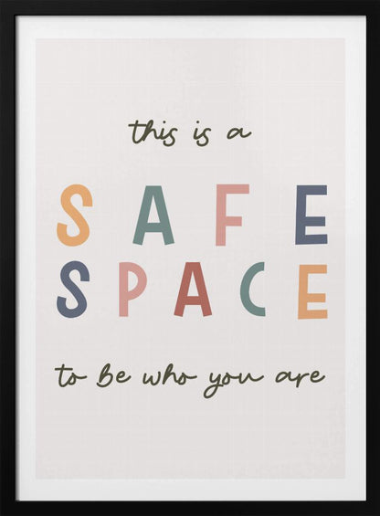 A framed poster with an inspirational message that reads 'this is a SAFE SPACE to be who you are'. The words 'SAFE SPACE' are in large, block letters of various muted colors like orange, sage, pink, and blue, while the rest of the text is in a smaller, dark green script font on an off-white background. Poster