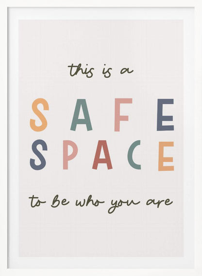 A framed poster with an inspirational message that reads 'this is a SAFE SPACE to be who you are'. The words 'SAFE SPACE' are in large, block letters of various muted colors like orange, sage, pink, and blue, while the rest of the text is in a smaller, dark green script font on an off-white background. Poster