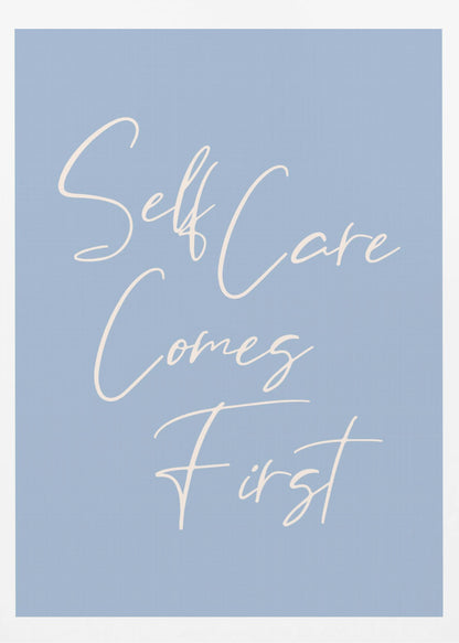 A framed poster featuring the phrase 'Self Care Comes First' in an elegant, off-white cursive font against a solid light blue background. The artwork is enclosed in a simple black frame. Decor