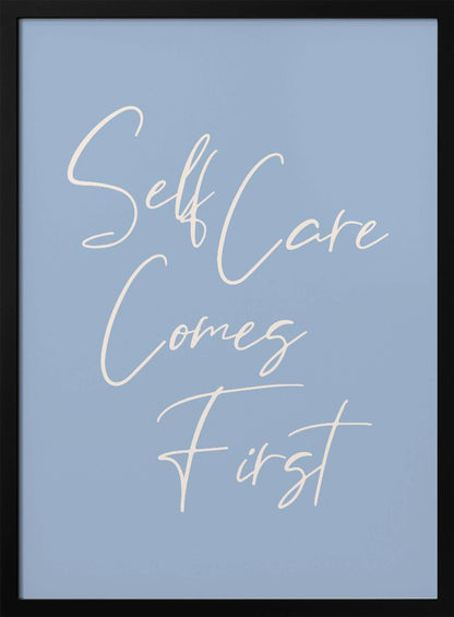 A framed poster featuring the phrase 'Self Care Comes First' in an elegant, off-white cursive font against a solid light blue background. The artwork is enclosed in a simple black frame. Decor