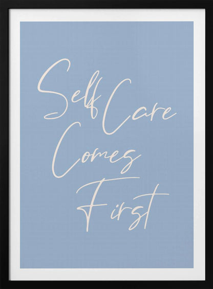 A framed poster featuring the phrase 'Self Care Comes First' in an elegant, off-white cursive font against a solid light blue background. The artwork is enclosed in a simple black frame. Decor