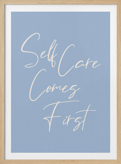 A framed poster featuring the phrase 'Self Care Comes First' in an elegant, off-white cursive font against a solid light blue background. The artwork is enclosed in a simple black frame. Decor