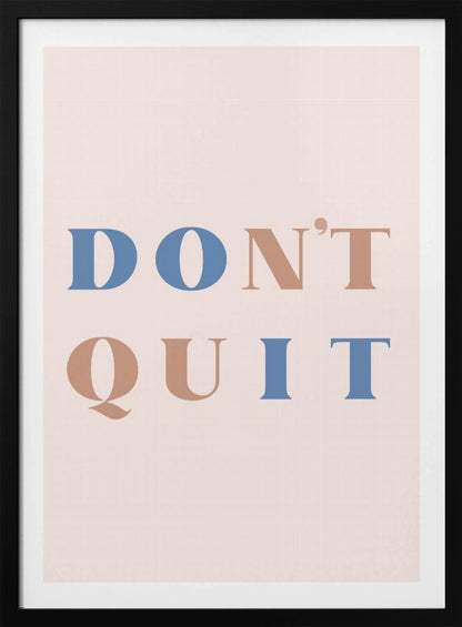 A minimalist motivational art print with a pale pink background and a thin black frame. The text reads 'DON'T QUIT' in a large serif font, with the words 'DO' and 'IT' highlighted in blue and the words 'N'T' and 'QU' in a muted terracotta color, creating a hidden 'DO IT' message. Decor