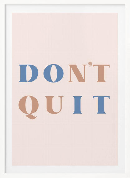 A minimalist motivational art print with a pale pink background and a thin black frame. The text reads 'DON'T QUIT' in a large serif font, with the words 'DO' and 'IT' highlighted in blue and the words 'N'T' and 'QU' in a muted terracotta color, creating a hidden 'DO IT' message. Decor