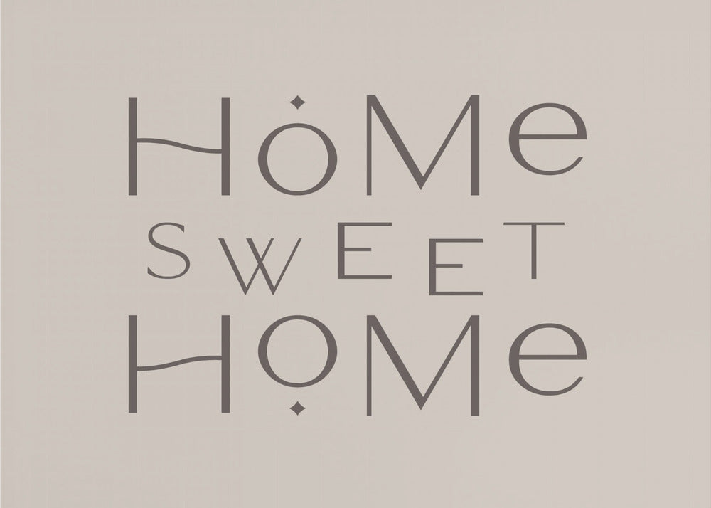 A minimalist wall art piece with the words 'Home Sweet Home' in a dark gray, stylized sans-serif font against a light beige background, all housed within a simple silver frame. Decor