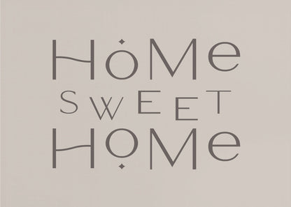 A minimalist wall art piece with the words 'Home Sweet Home' in a dark gray, stylized sans-serif font against a light beige background, all housed within a simple silver frame. Decor