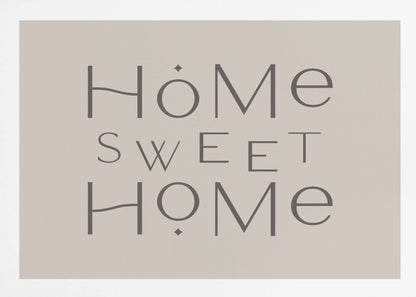 A minimalist wall art piece with the words 'Home Sweet Home' in a dark gray, stylized sans-serif font against a light beige background, all housed within a simple silver frame. Decor