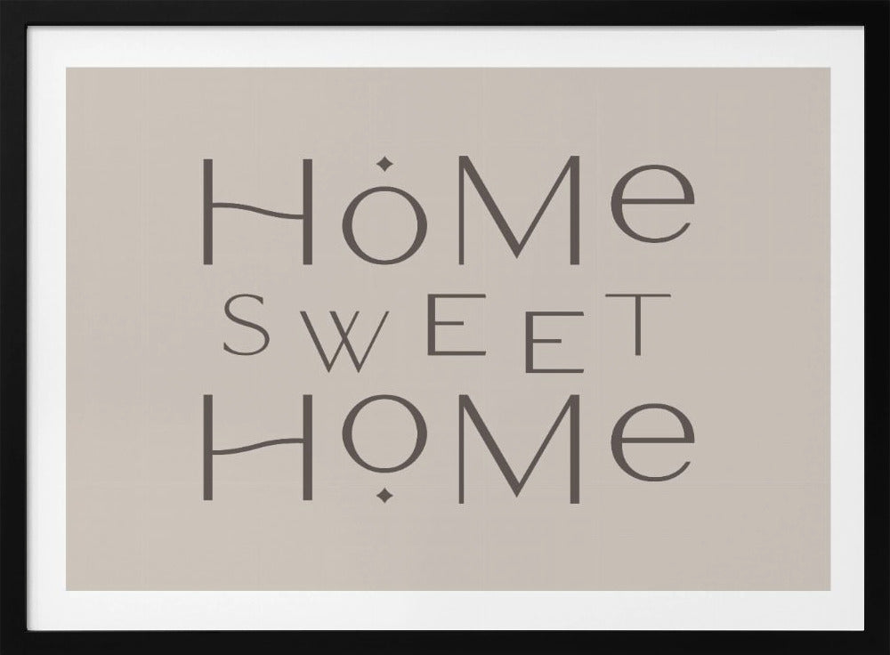 A minimalist wall art piece with the words 'Home Sweet Home' in a dark gray, stylized sans-serif font against a light beige background, all housed within a simple silver frame. Decor