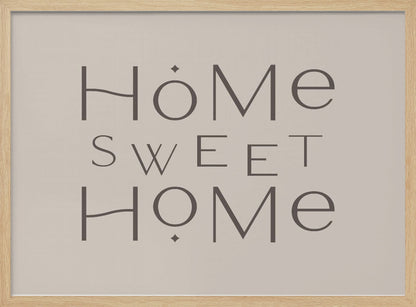 A minimalist wall art piece with the words 'Home Sweet Home' in a dark gray, stylized sans-serif font against a light beige background, all housed within a simple silver frame. Decor