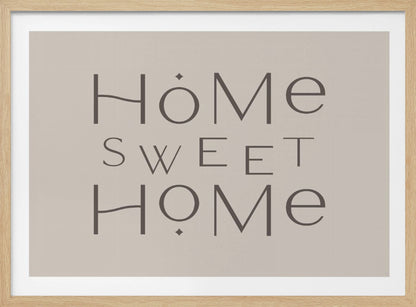 A minimalist wall art piece with the words 'Home Sweet Home' in a dark gray, stylized sans-serif font against a light beige background, all housed within a simple silver frame. Decor