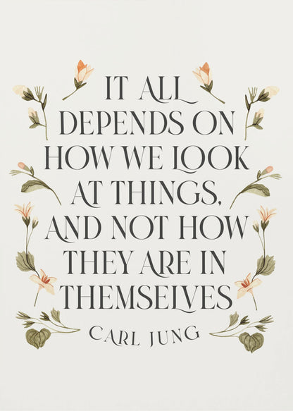 A framed art print featuring an inspirational quote by Carl Jung. The text reads 'It all depends on how we look at things, and not how they are in themselves' in a black serif font against an off-white background. The quote is encircled by a delicate wreath of watercolor botanicals with green leaves and pale orange flowers. Poster