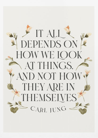 A framed art print featuring an inspirational quote by Carl Jung. The text reads 'It all depends on how we look at things, and not how they are in themselves' in a black serif font against an off-white background. The quote is encircled by a delicate wreath of watercolor botanicals with green leaves and pale orange flowers. Poster