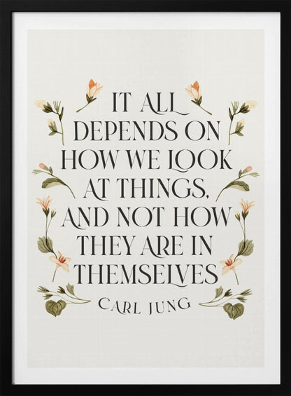 A framed art print featuring an inspirational quote by Carl Jung. The text reads 'It all depends on how we look at things, and not how they are in themselves' in a black serif font against an off-white background. The quote is encircled by a delicate wreath of watercolor botanicals with green leaves and pale orange flowers. Poster