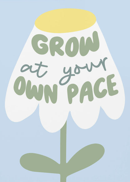 A motivational art print featuring a stylized white flower with a yellow center and green stem against a light blue background. The phrase 'GROW at your OWN PACE' is written in green, hand-drawn lettering across the flower's petals. Artwork