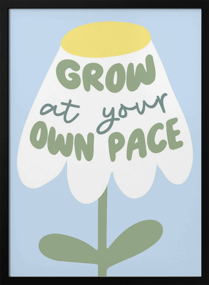 A motivational art print featuring a stylized white flower with a yellow center and green stem against a light blue background. The phrase 'GROW at your OWN PACE' is written in green, hand-drawn lettering across the flower's petals. Artwork