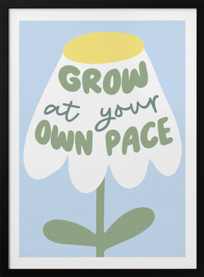A motivational art print featuring a stylized white flower with a yellow center and green stem against a light blue background. The phrase 'GROW at your OWN PACE' is written in green, hand-drawn lettering across the flower's petals. Artwork
