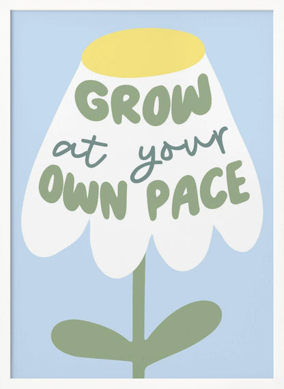 A motivational art print featuring a stylized white flower with a yellow center and green stem against a light blue background. The phrase 'GROW at your OWN PACE' is written in green, hand-drawn lettering across the flower's petals. Artwork