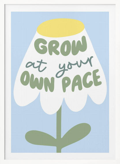 A motivational art print featuring a stylized white flower with a yellow center and green stem against a light blue background. The phrase 'GROW at your OWN PACE' is written in green, hand-drawn lettering across the flower's petals. Artwork