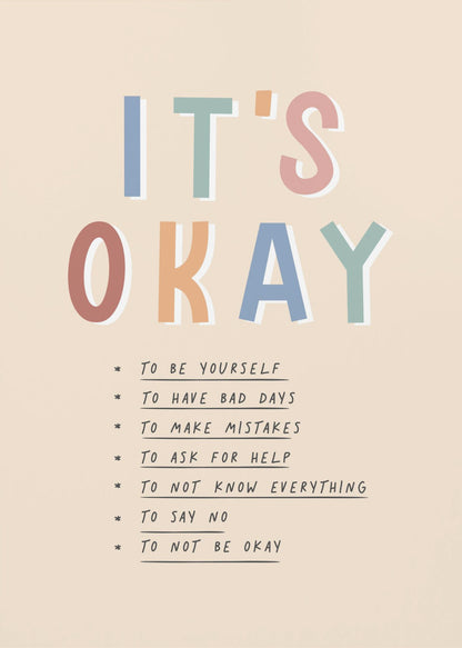 An inspirational framed poster with the words 'IT'S OKAY' in large, colorful letters. Below is a list of affirmations including 'TO BE YOURSELF', 'TO HAVE BAD DAYS', and 'TO MAKE MISTAKES' on a beige background. Artwork
