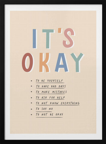 An inspirational framed poster with the words 'IT'S OKAY' in large, colorful letters. Below is a list of affirmations including 'TO BE YOURSELF', 'TO HAVE BAD DAYS', and 'TO MAKE MISTAKES' on a beige background. Artwork