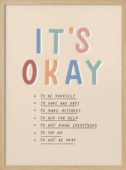 An inspirational framed poster with the words 'IT'S OKAY' in large, colorful letters. Below is a list of affirmations including 'TO BE YOURSELF', 'TO HAVE BAD DAYS', and 'TO MAKE MISTAKES' on a beige background. Artwork