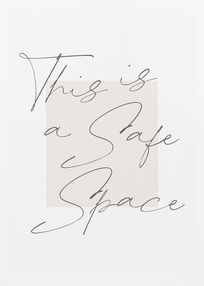 A minimalist art print in a black frame with the words 'This is a Safe Space' written in a flowing black cursive script over a pale beige rectangle on a white background. Artwork