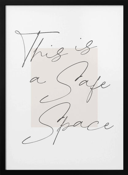 A minimalist art print in a black frame with the words 'This is a Safe Space' written in a flowing black cursive script over a pale beige rectangle on a white background. Artwork