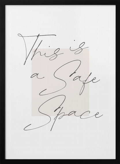 A minimalist art print in a black frame with the words 'This is a Safe Space' written in a flowing black cursive script over a pale beige rectangle on a white background. Artwork