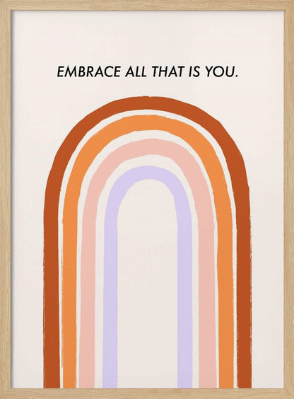 A framed art print with an inspirational quote. On a cream background, the black text reads 'EMBRACE ALL THAT IS YOU.' Below the text is a large, stylized U-shaped rainbow with thick, painted bands of terracotta, orange, pink, and lavender. Print