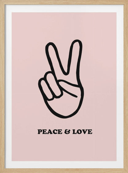 A minimalist art print with a light pink background featuring a bold black outline of a hand making a peace sign. Below the hand, the words 'PEACE & LOVE' are printed in a black serif font. The print is enclosed in a simple black frame. Print
