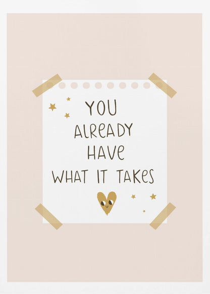 A motivational poster in a black frame with a pale pink background. A white piece of notebook paper is taped to the center with the handwritten text 'YOU ALREADY HAVE WHAT IT TAKES' in brown. It's decorated with small gold stars and a cute, smiling gold heart. Decor