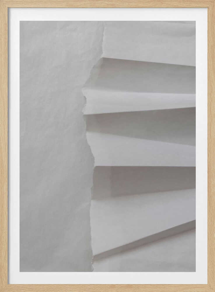 A minimalist composition of folded and torn white paper, showcasing geometric forms and shadows in a black frame.