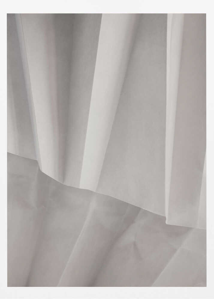 Abstract art print of folded white fabric or paper creating soft lines and deep shadows.