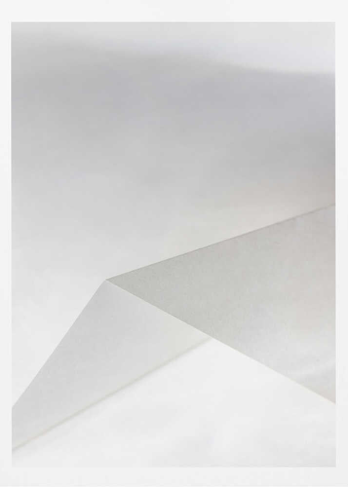 Minimalist abstract art of folded paper creating clean lines and geometric shapes in shades of grey and white.